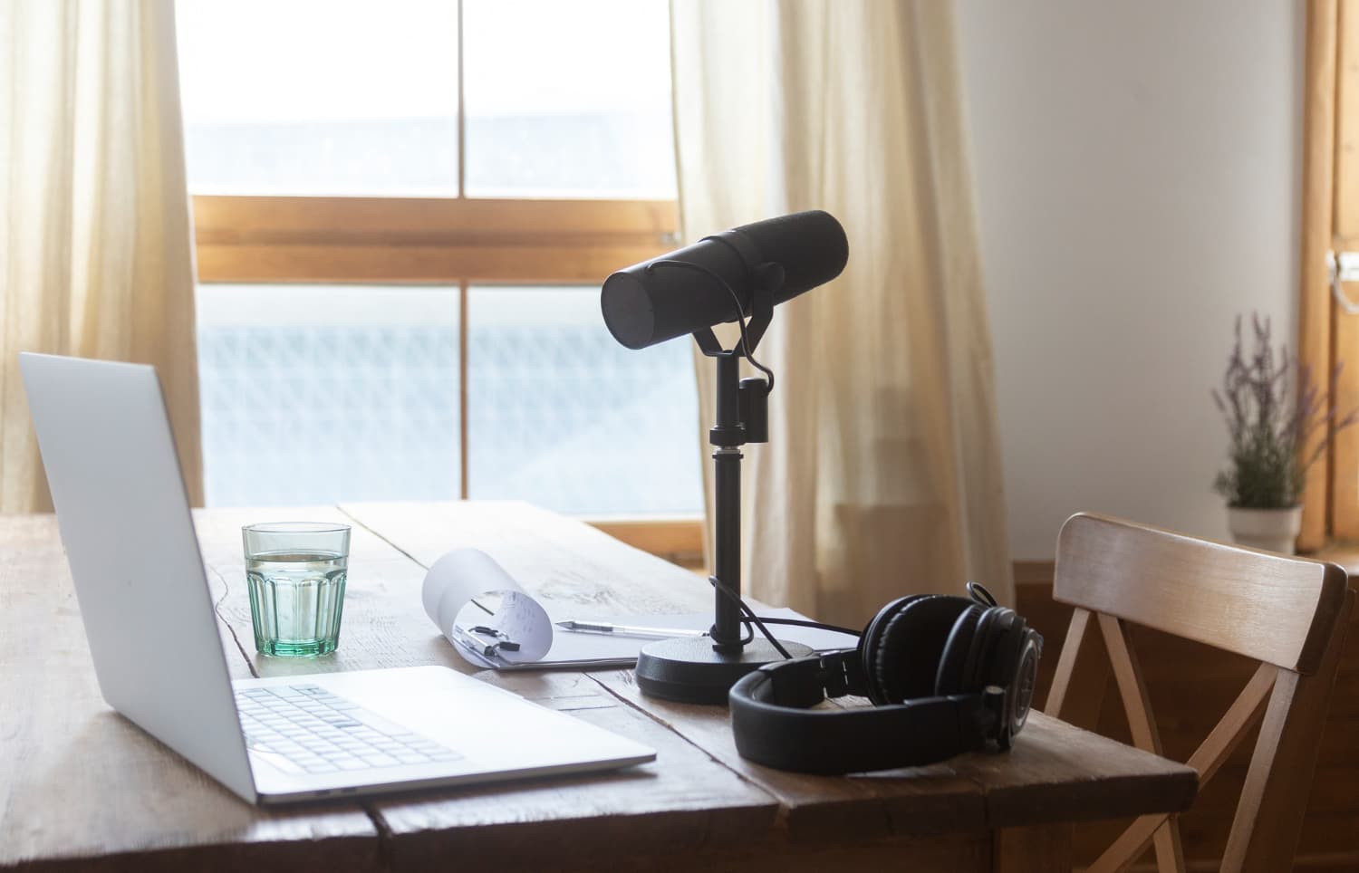 A RØDE podcast microphone — the setup Rooted and Routed is recorded on